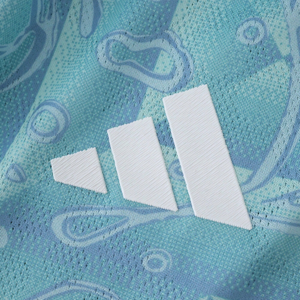 Close-up of the Adidas logo on the Juventus 2025/26 Away Player Version jersey in light blue.