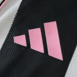 Close-up of the pink Adidas logo on the 2025/26 Juventus Home Player Version jersey.