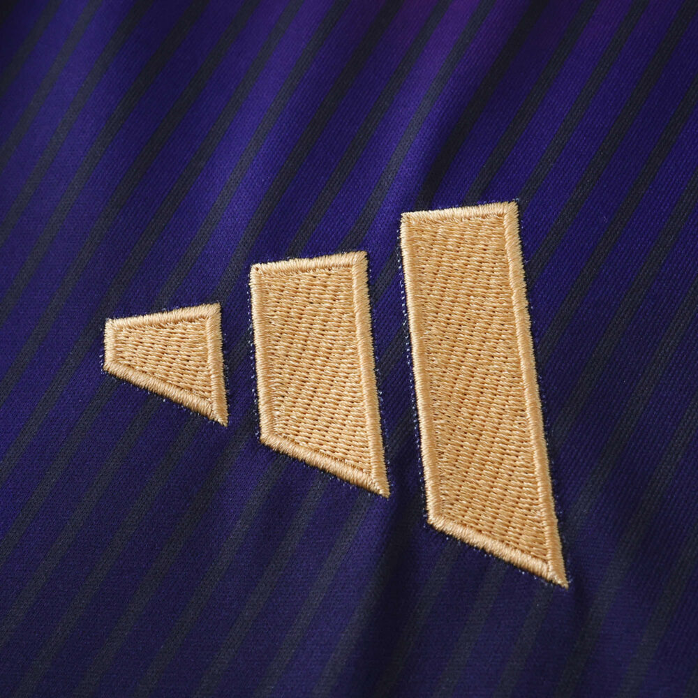Close-up of the gold Adidas logo on the dark blue LA Galaxy Away 2025/26 Fan Version jersey.