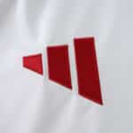 Close-up of the red Adidas logo on the white Liverpool Away 2025/26 Fan Version jersey.