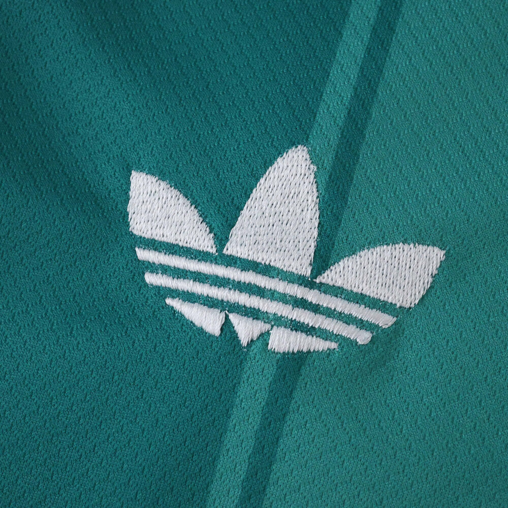 White Adidas Trefoil logo embroidered on teal Liverpool Third 2025/26 Fan Version jersey fabric.