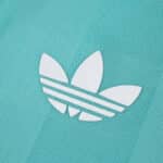Close-up of the white Adidas logo on the Liverpool Third 2025/26 Player Version jersey in teal.