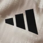 Close-up of the black adidas logo on the New York Red Bulls 2025/26 away player version jersey fabric.