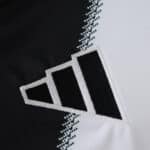 Close-up of the Newcastle United Home 2025/26 fan jersey featuring the Adidas logo on black and white fabric.