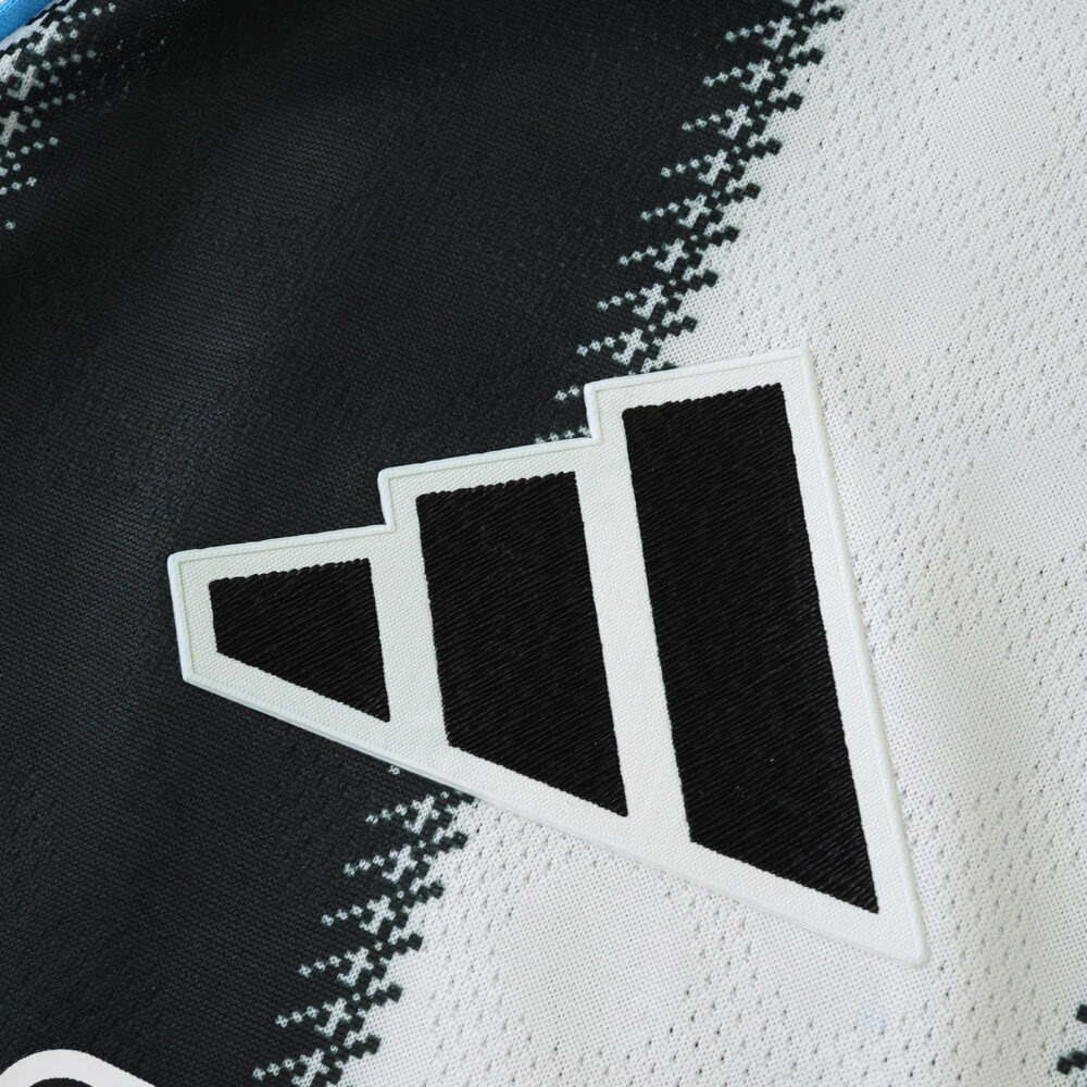 Close-up of the Adidas logo on the Newcastle United 2025/26 home player version jersey.