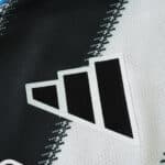 Close-up of the Adidas logo on the Newcastle United 2025/26 home player version jersey.