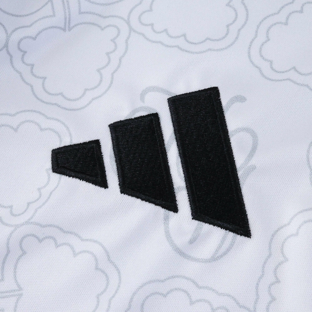 Close-up of the Nottingham Forest Away 2025/26 Fan Version jersey with Adidas logo on patterned white fabric.