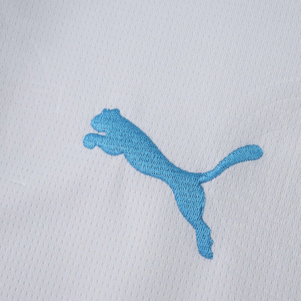 Close-up of the blue Puma logo on the Olympique Marseille 2025/26 Home Fan Version jersey fabric.