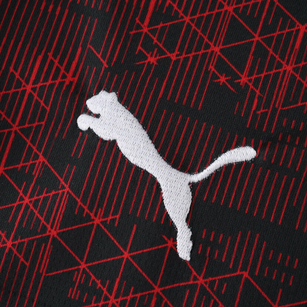 Close-up of RB Leipzig Third 2025/26 Fan Version jersey fabric with white Puma logo and red graphic pattern.