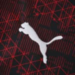 Close-up of RB Leipzig Third 2025/26 Fan Version jersey fabric with white Puma logo and red graphic pattern.