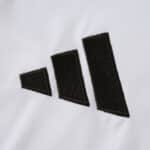 Close-up of the black Adidas logo on the Real Madrid 2025/26 Home Fan Version jersey.