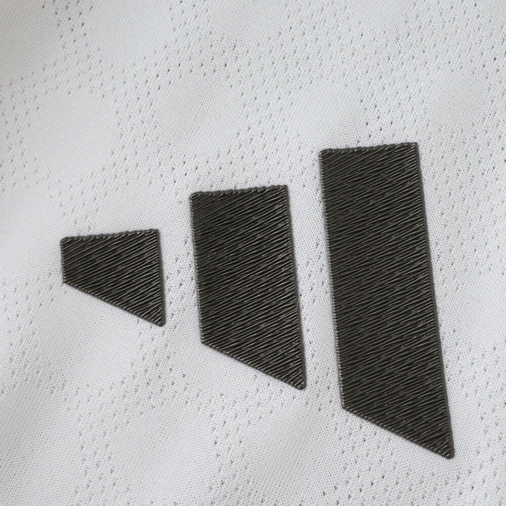 Close-up of the 2025/26 Real Madrid Home Player Version jersey showing the black Adidas logo on white fabric.