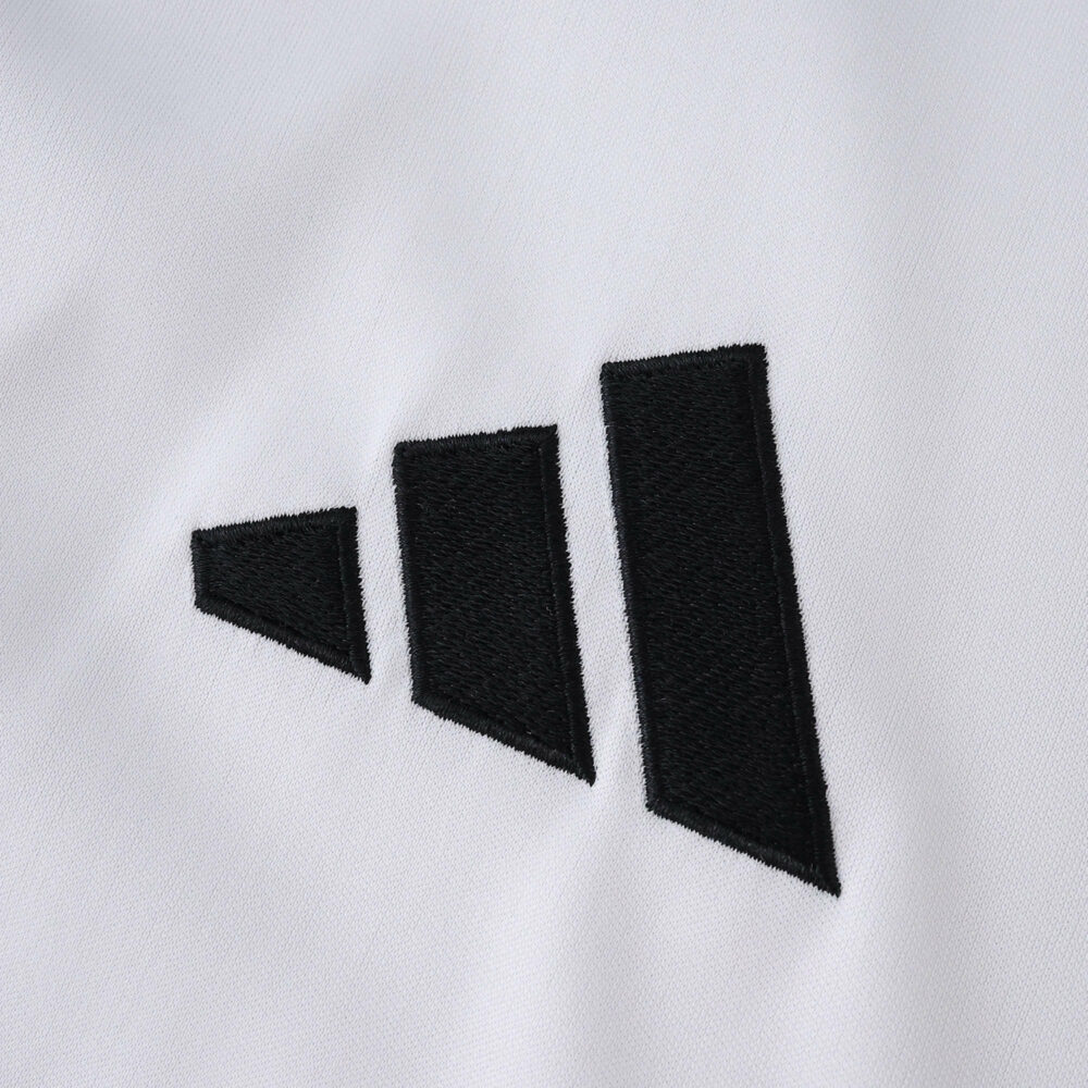 Close-up of the Adidas logo on the River Plate Home 2025/26 Fan Version jersey fabric.