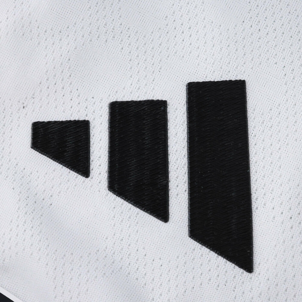 Close-up of the Adidas logo on the 2025/26 River Plate Home Player Version jersey fabric.