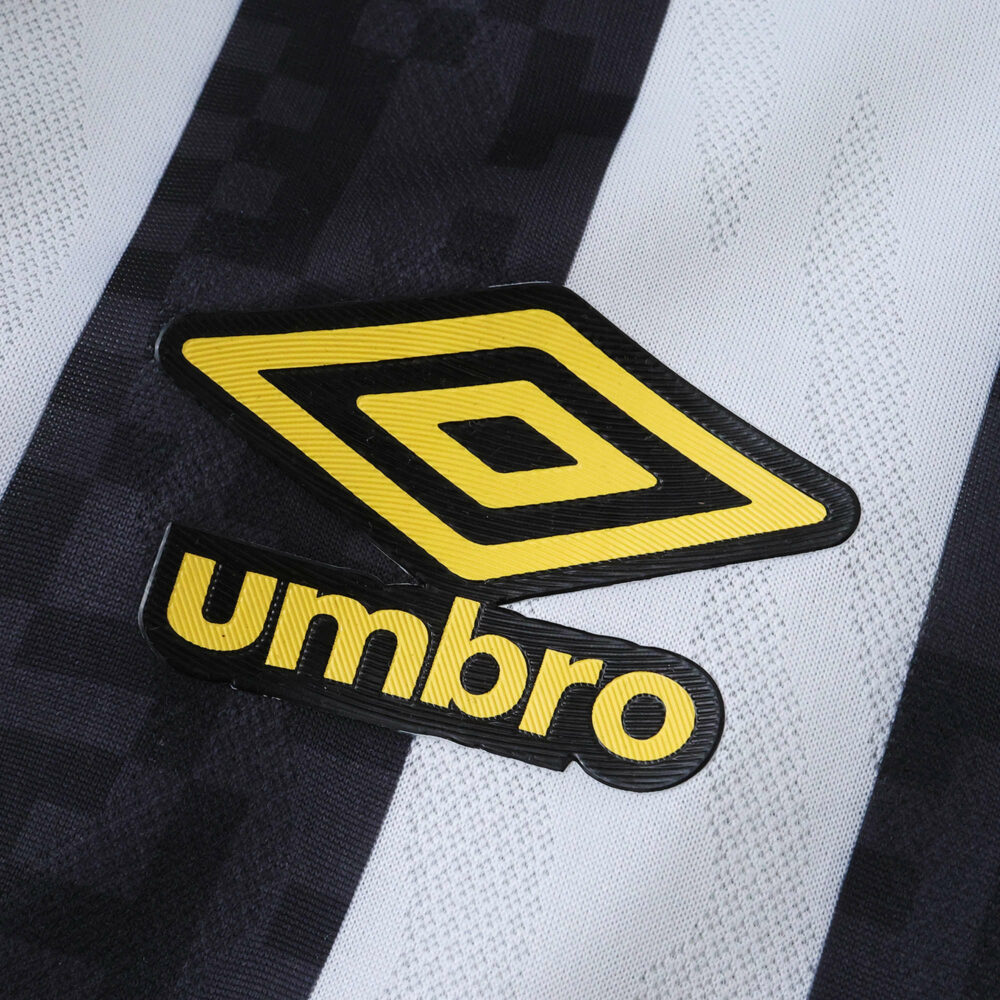Close-up of yellow Umbro logo on black and white Santos FC Away 2025/26 Fan Version jersey fabric.