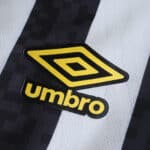 Close-up of yellow Umbro logo on black and white Santos FC Away 2025/26 Fan Version jersey fabric.