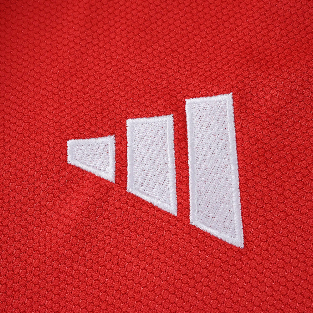 Close-up of the adidas logo on the red SL Benfica 2025/26 Home Fan Version jersey fabric.