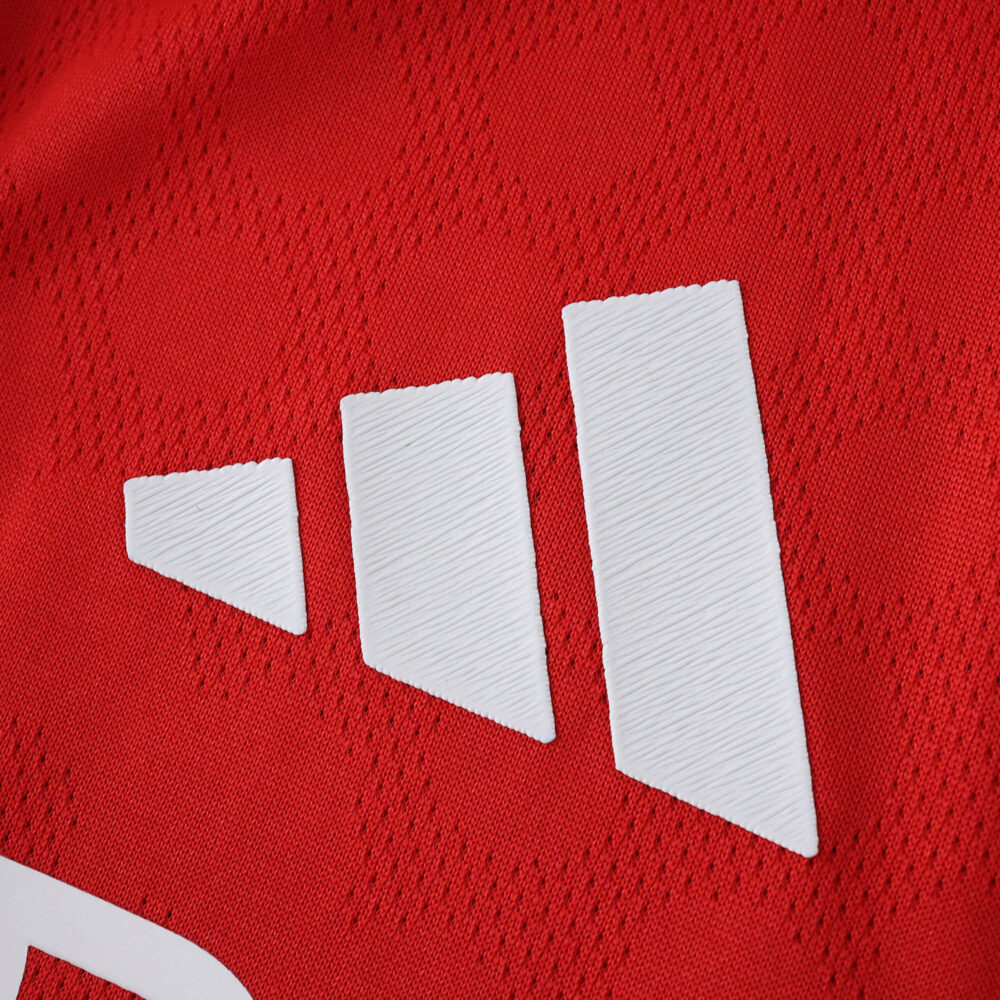 Close-up of the adidas logo on the red SL Benfica Home 2025/26 Player Version jersey fabric.