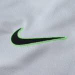 Close-up of the Nike logo on the VfL Wolfsburg 2025/26 Away Fan Version jersey in light gray fabric.