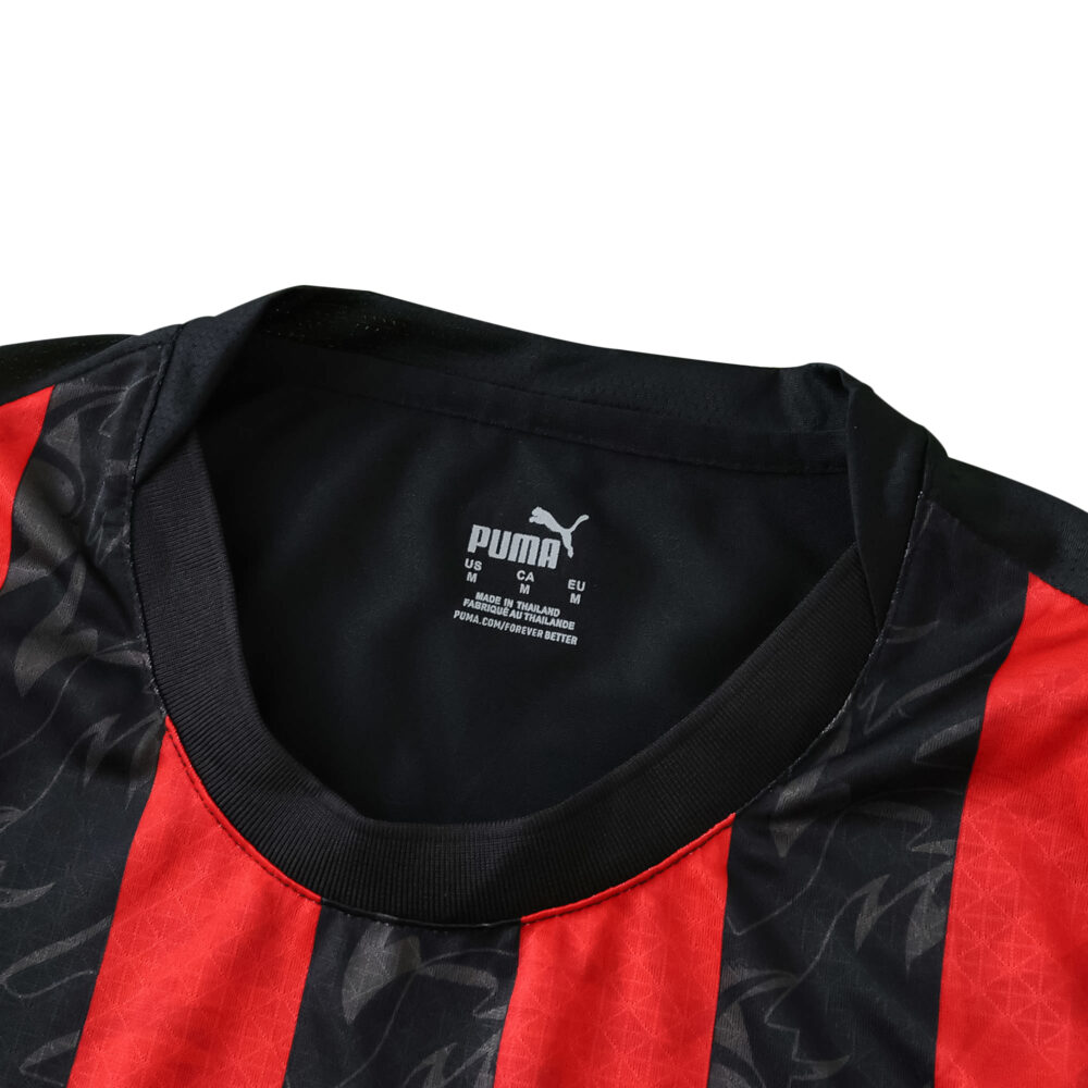 Close-up of AC Milan 2025/26 Home Player Version jersey collar with Puma logo and red-black stripes.