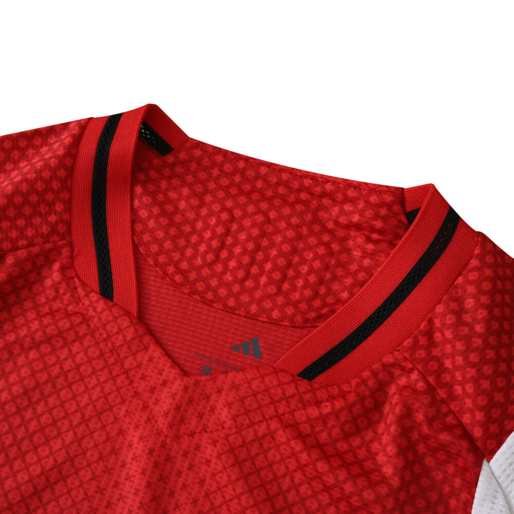 Close-up of Ajax Home 2025/26 Player Version jersey collar with red fabric and black trim.