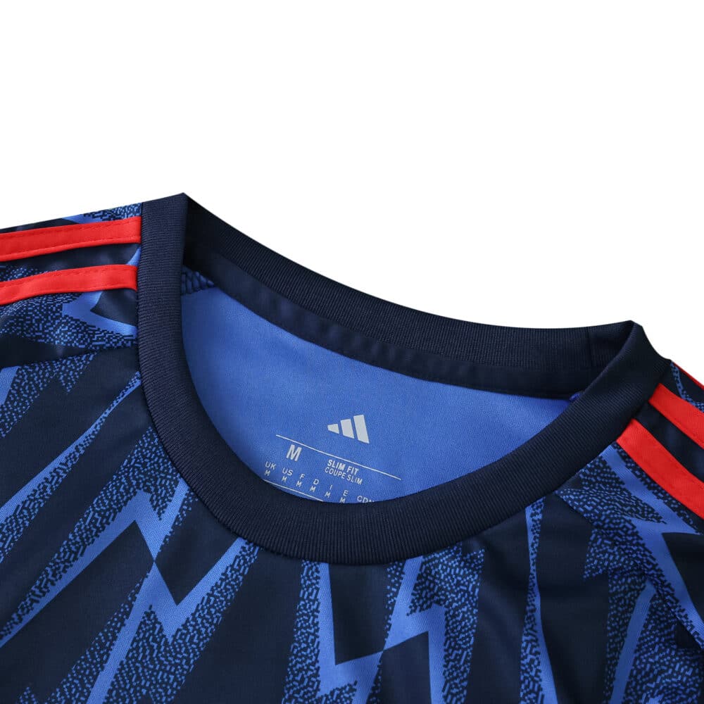 Close-up of Arsenal Away 2025/26 Fan Version jersey collar with blue patterns and red Adidas stripes.