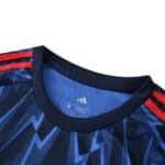 Close-up of Arsenal Away 2025/26 Fan Version jersey collar with blue patterns and red Adidas stripes.
