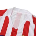 Close-up of the Atlético Madrid 2025/26 home fan jersey collar with red and white stripes.