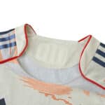 Close-up of the Bayern Munich 2025/26 away player version jersey collar with red trim and navy stripes.