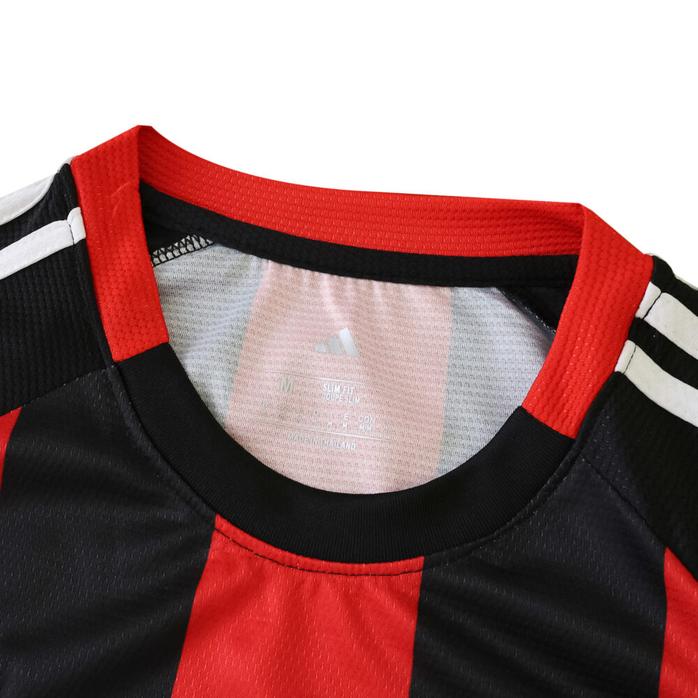 Close-up of Eintracht Frankfurt 2025/26 home fan jersey collar with black and red stripes and Adidas logo.