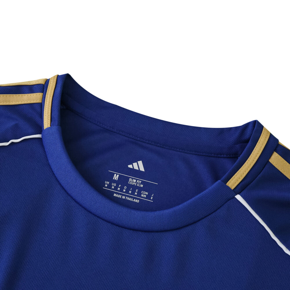 Close-up of the Hamburger SV Away 2025/26 Fan Version jersey collar in blue with gold accents.