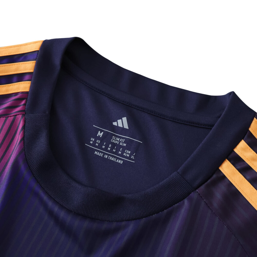 Close-up of LA Galaxy Away 2025/26 Fan Version jersey collar with gold stripes on dark fabric.