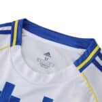 Close-up of Leeds United 2025/26 Home Fan Version jersey collar, showing blue and yellow trim.
