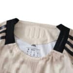 Collar detail of New York Red Bulls Away 2025/26 Player Version jersey with black shoulder stripes.