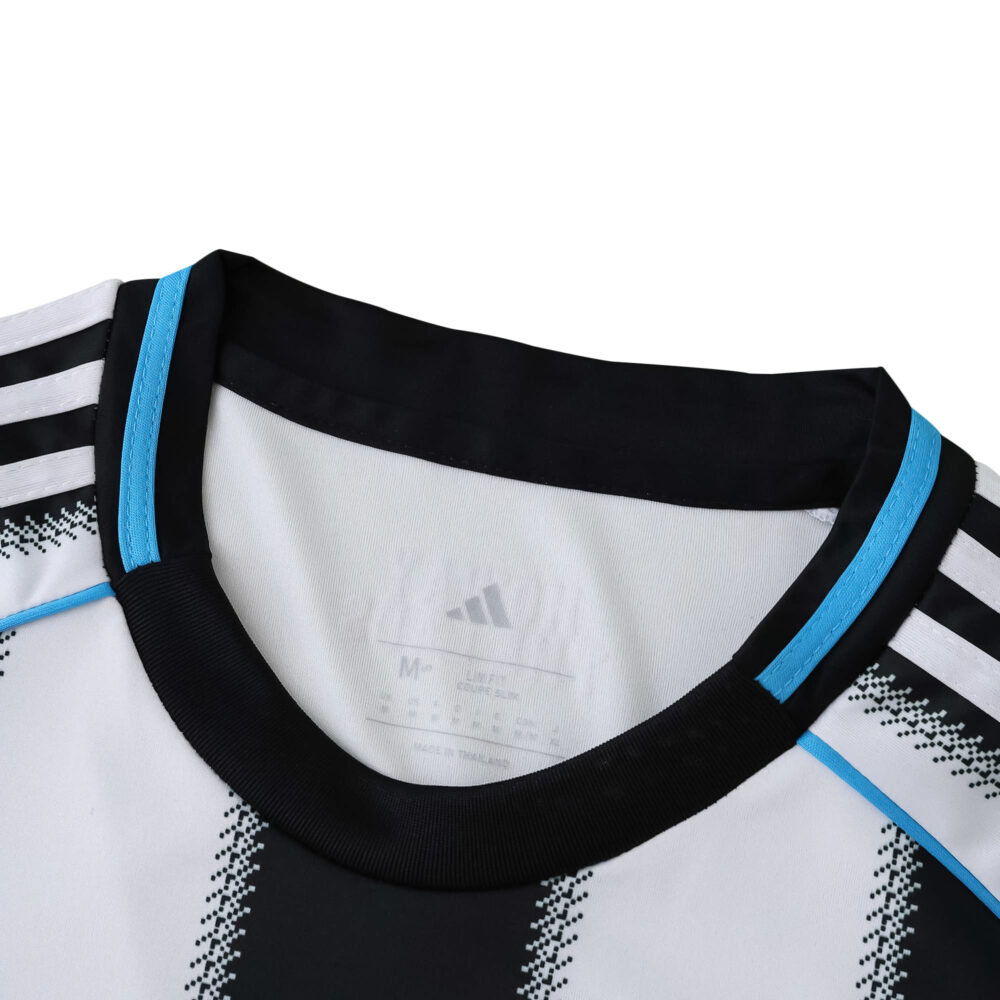 Close-up of Newcastle United 2025/26 home jersey collar, featuring black and blue trim with Adidas stripes.