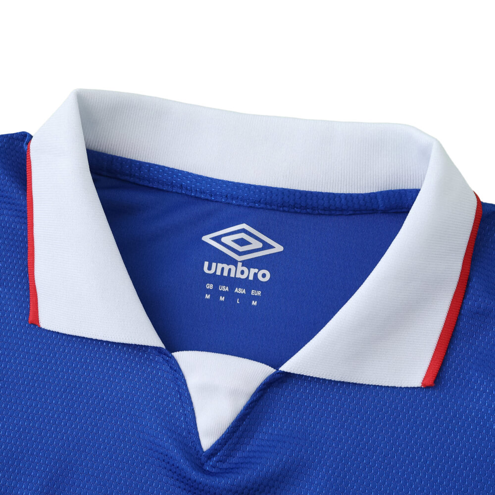 Close-up of Rangers Home 2025/26 fan version jersey collar, featuring blue fabric and white trim with red accents.