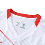 Close-up of the RB Leipzig 2025/26 home fan jersey collar with red trim and visible Puma branding.