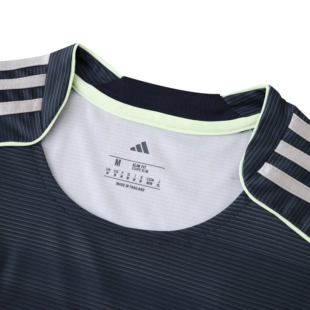 Close-up of the Real Madrid 2025/26 away fan jersey collar with Adidas logo and size label.