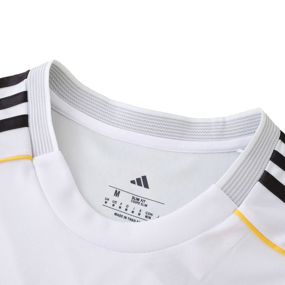 Close-up of the Real Madrid 2025/26 home fan jersey collar with Adidas logo and black shoulder stripes.