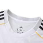 Close-up of the Real Madrid 2025/26 home fan jersey collar with Adidas logo and black shoulder stripes.