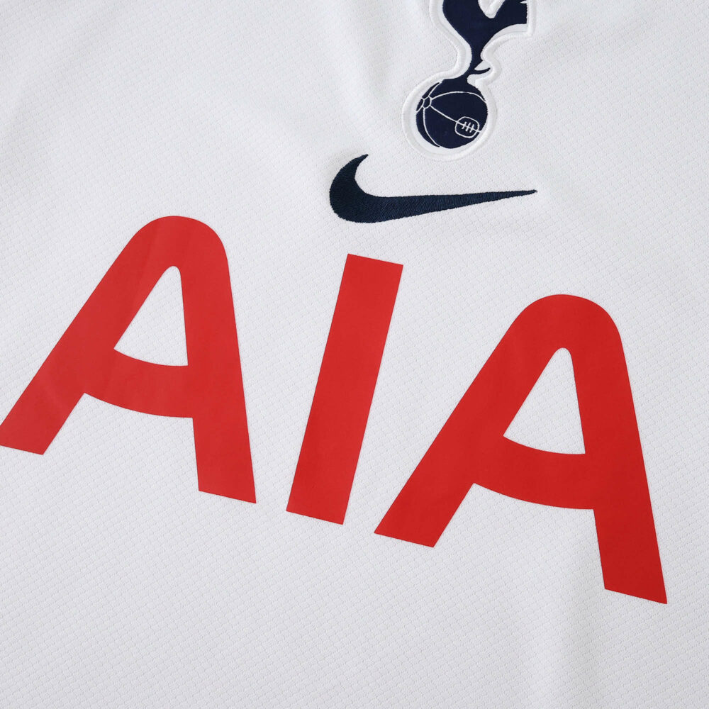 Close-up of the 2025/26 Tottenham Hotspur home jersey with crest, Nike logo, and AIA sponsor.