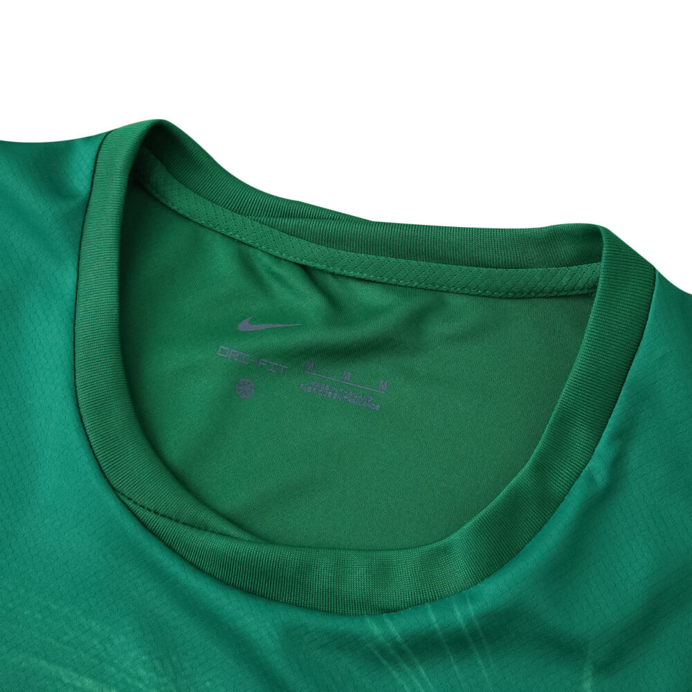 Close-up of the collar on the VfL Wolfsburg 2025/26 home fan jersey in green.