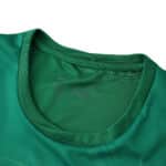 Close-up of the collar on the VfL Wolfsburg 2025/26 home fan jersey in green.