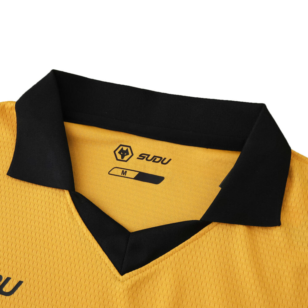 Close-up of the Wolverhampton Wanderers 2025/26 home fan jersey collar in gold with black trim.