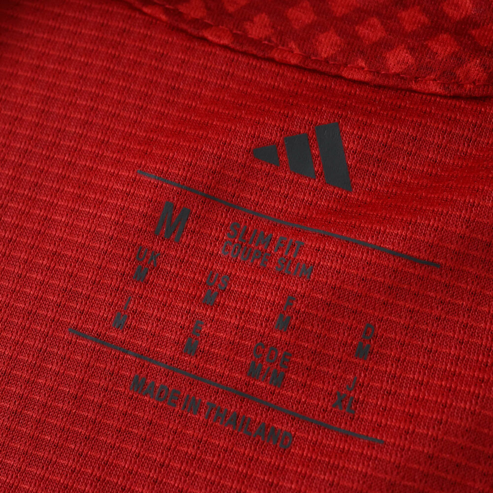 Close-up of the inner neck label on the Ajax 2025/26 Player Version jersey, showing size and Adidas logo.