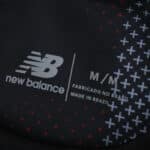 New Balance logo and size info on Bayer Leverkusen 2025/26 Home Fan Version jersey fabric, made in Brazil.