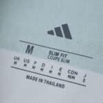 Close-up of the inner label on a Celtic Home 2025/26 Fan Version shirt, showing size and fit details.