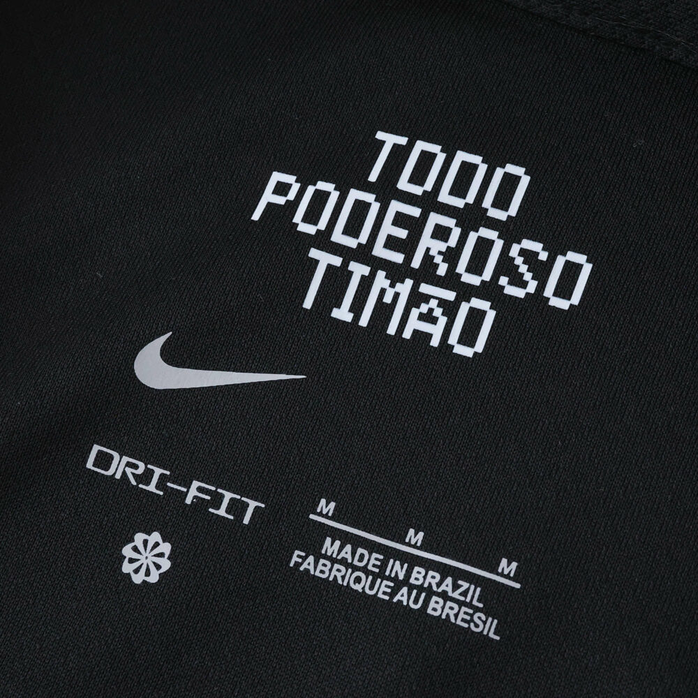 Detail of the Corinthians Away 2025/26 Fan Version jersey showing "Todo Poderoso Timão" and product tags.