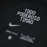 Detail of the Corinthians Away 2025/26 Fan Version jersey showing "Todo Poderoso Timão" and product tags.