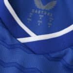 Close-up of the neckline and fabric details on the 2025/26 Everton Home Fan Version jersey by Castore.